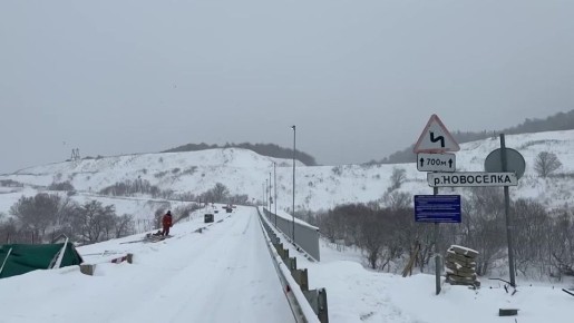 Непогода не мешает строителям вести работы на мосту через реку Новосёловку в Томаринском районе